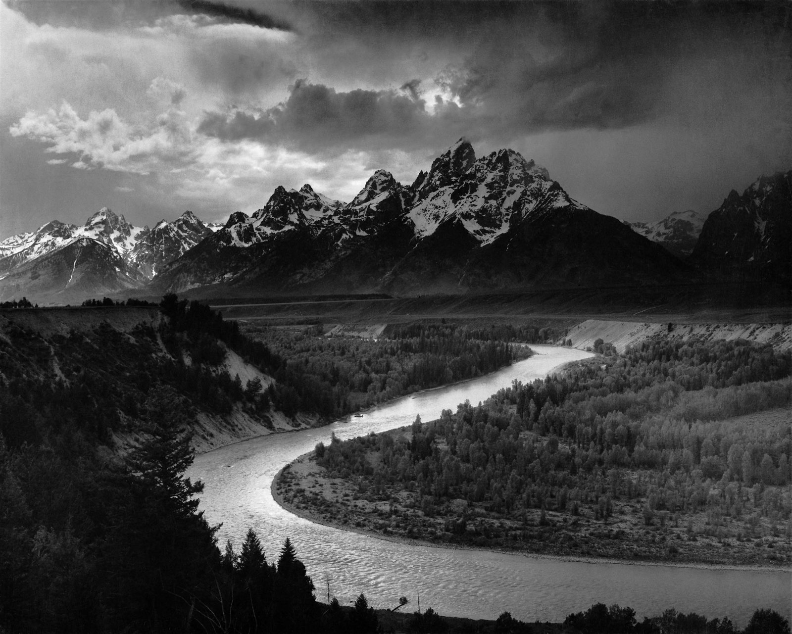 Ansel Adams, The Tetons and the Snake River, 1942. A river curves through a valley below jagged snow-covered mountains and a stormy sky.