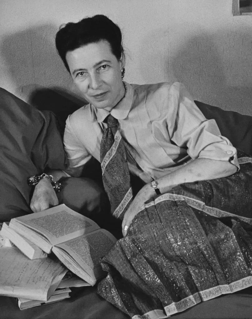 Photograph of Simone de Beauvoir, c. 1952. De Beauvoir is shown in her thirties, looking directly at the camera.